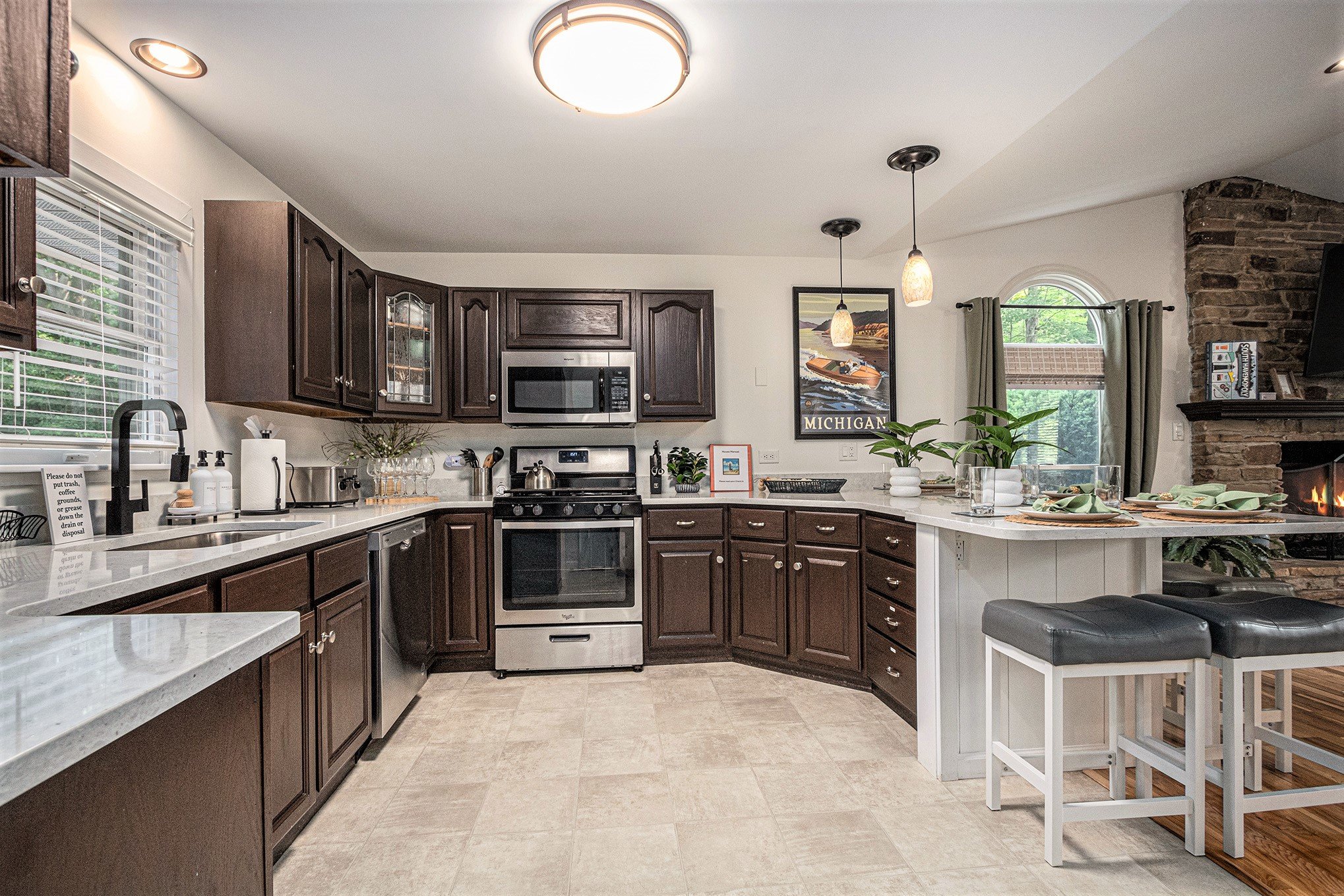 Modern kitchen with dark cabinets and stone fireplace