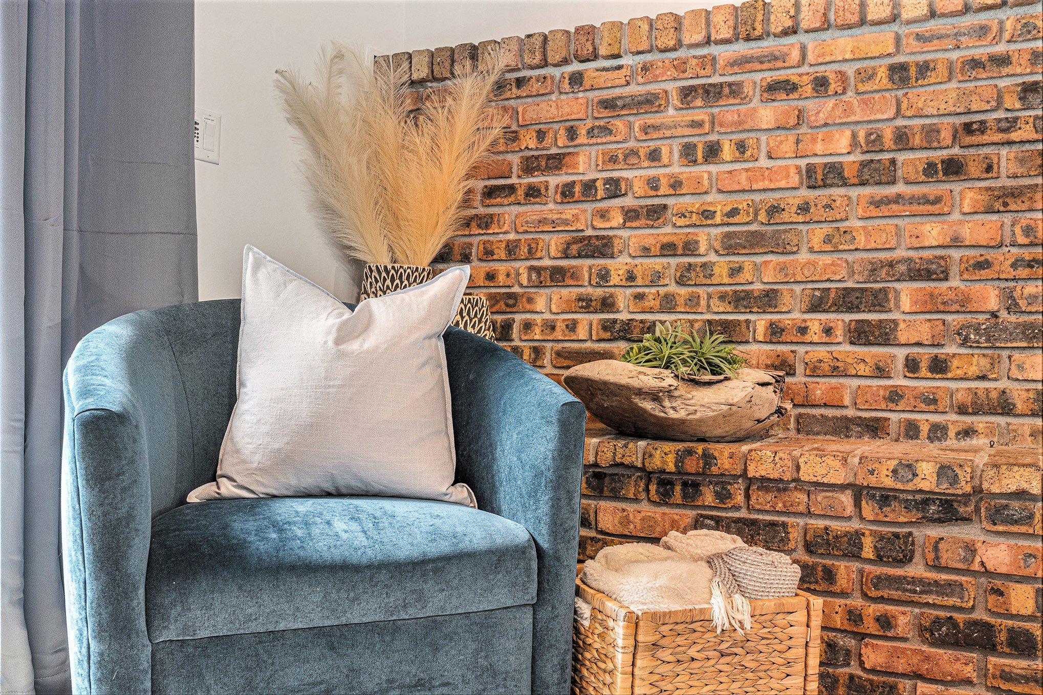 Cozy chair by rustic brick wall decor