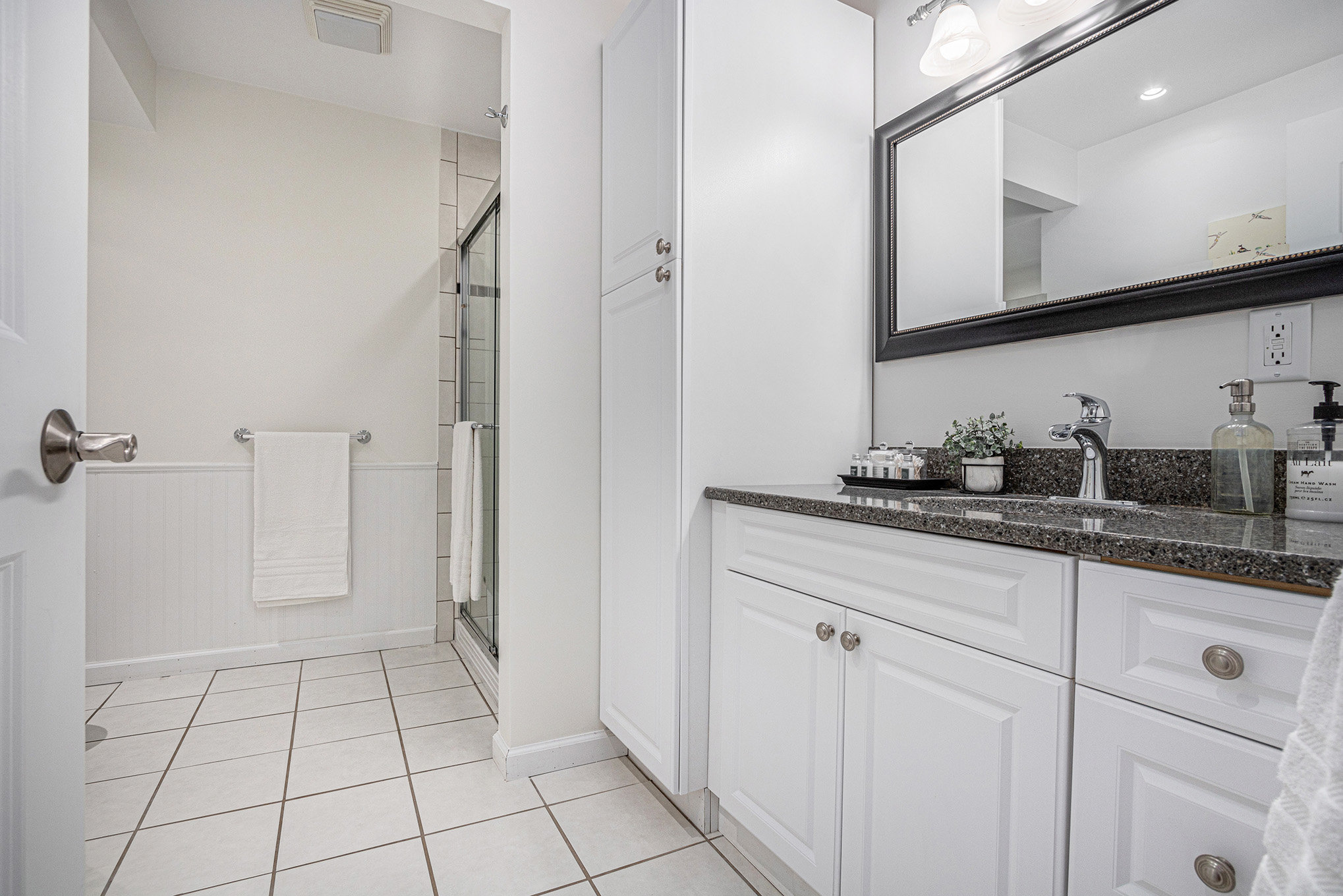 Modern white bathroom with shower and vanity