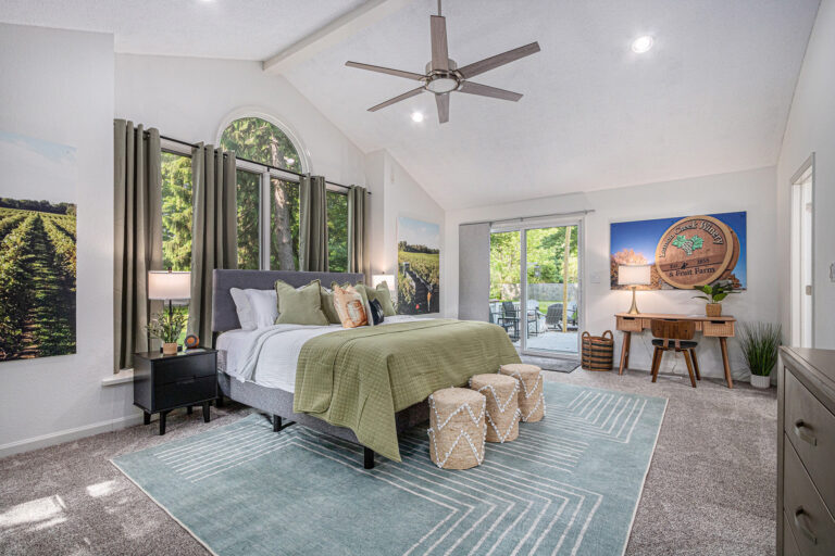 Modern bedroom with green decor and large windows
