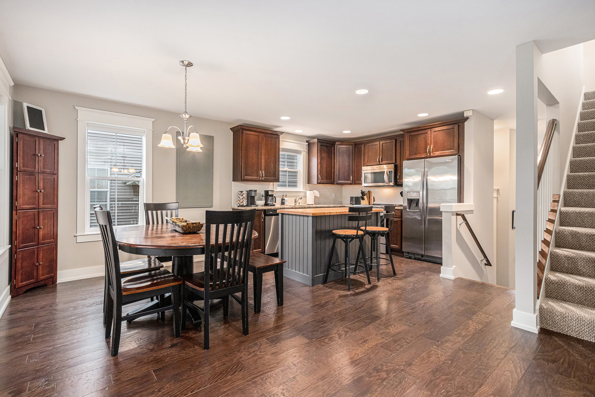 Modern kitchen and dining area with wood flooring