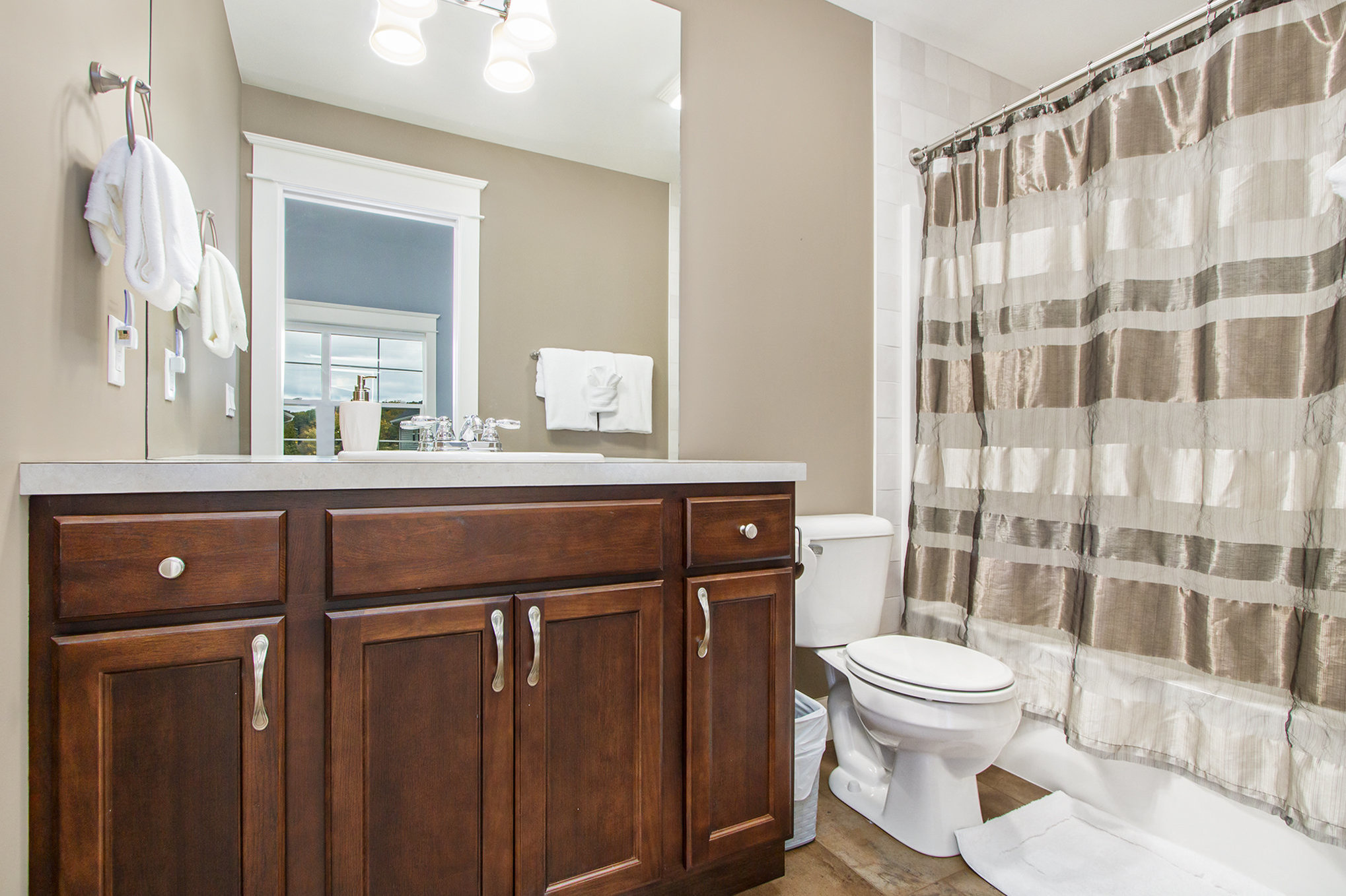 Modern bathroom with wooden vanity and shower curtain