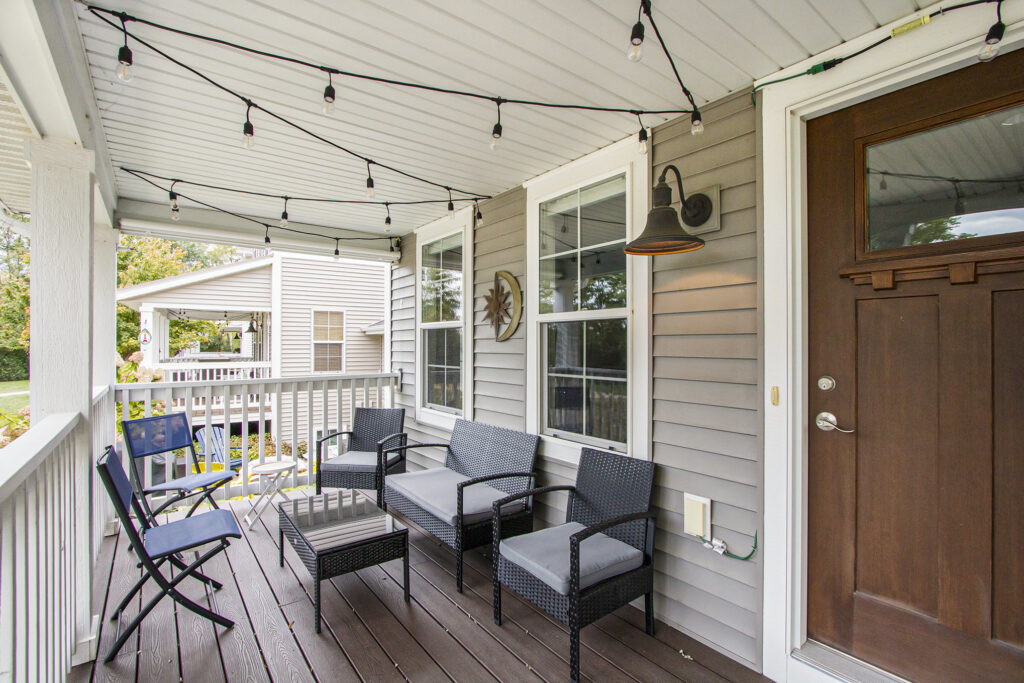 Cozy front porch with outdoor seating and lights