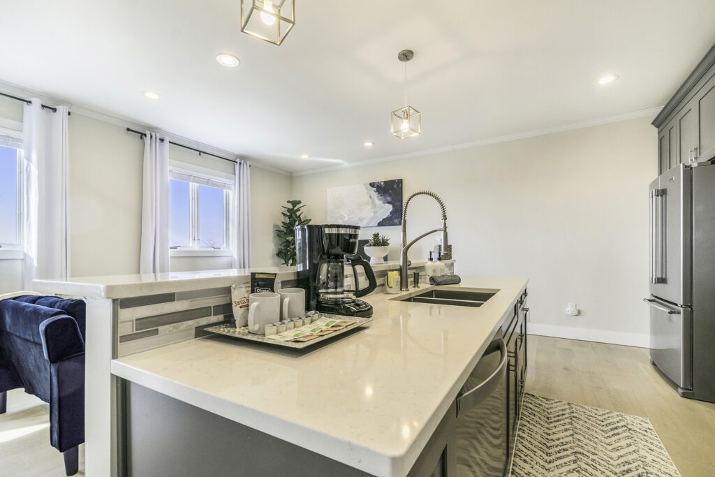 Modern kitchen with coffee maker and island sink