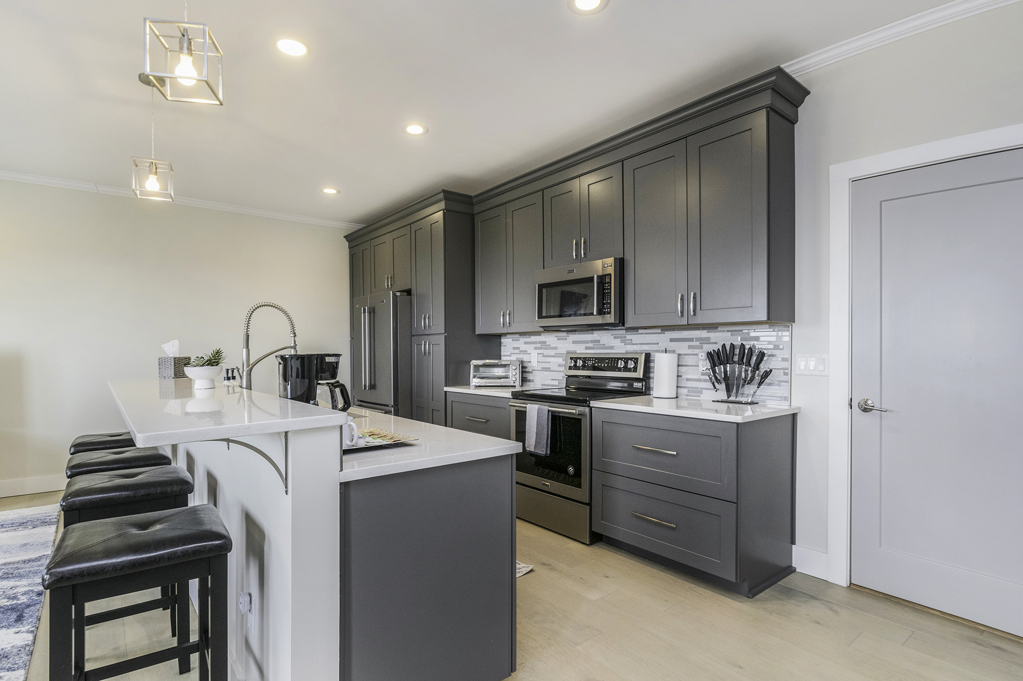 Modern kitchen with gray cabinets and white countertops