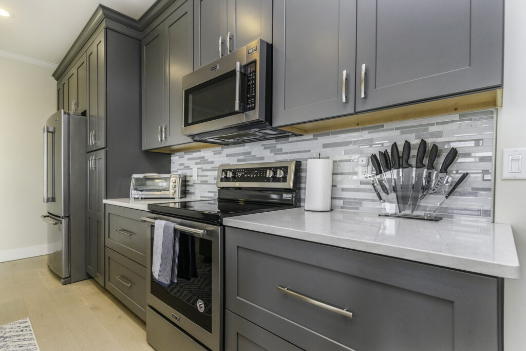 Modern kitchen with gray cabinets and stainless appliances