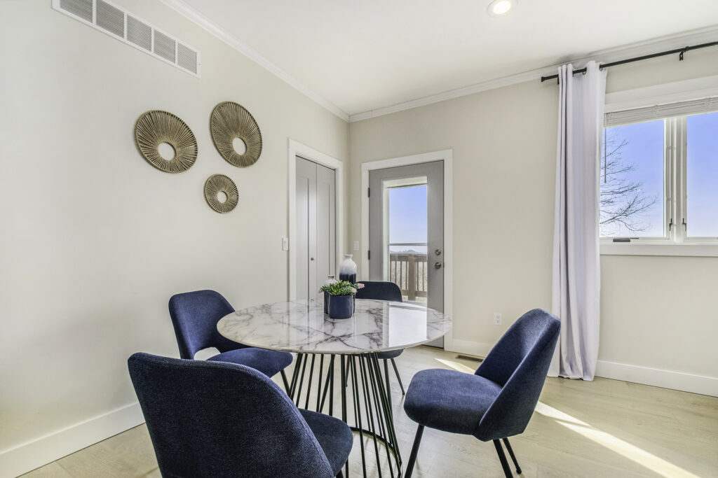 Modern dining area with marble table and blue chairs