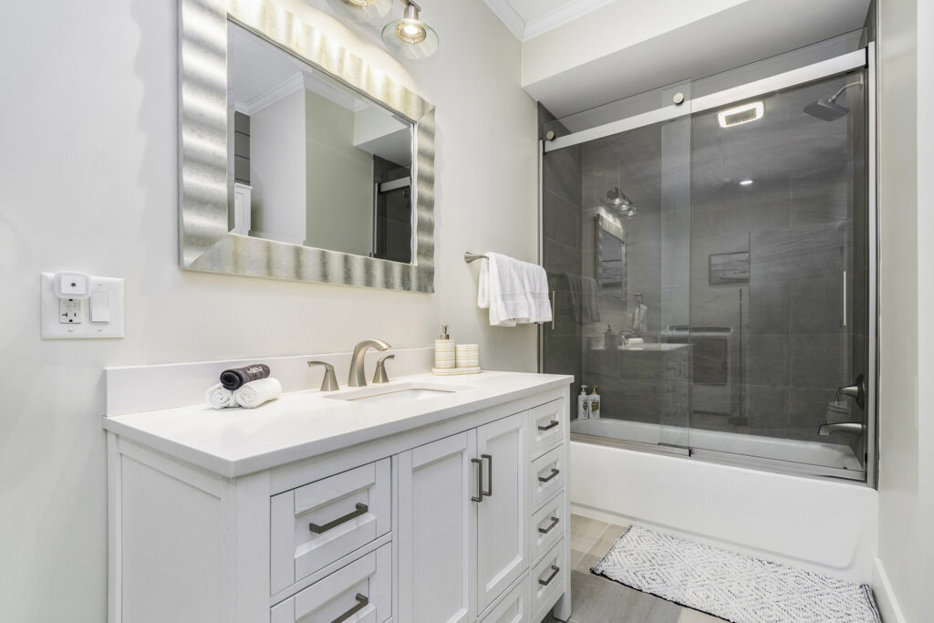 Modern white bathroom with glass shower enclosure