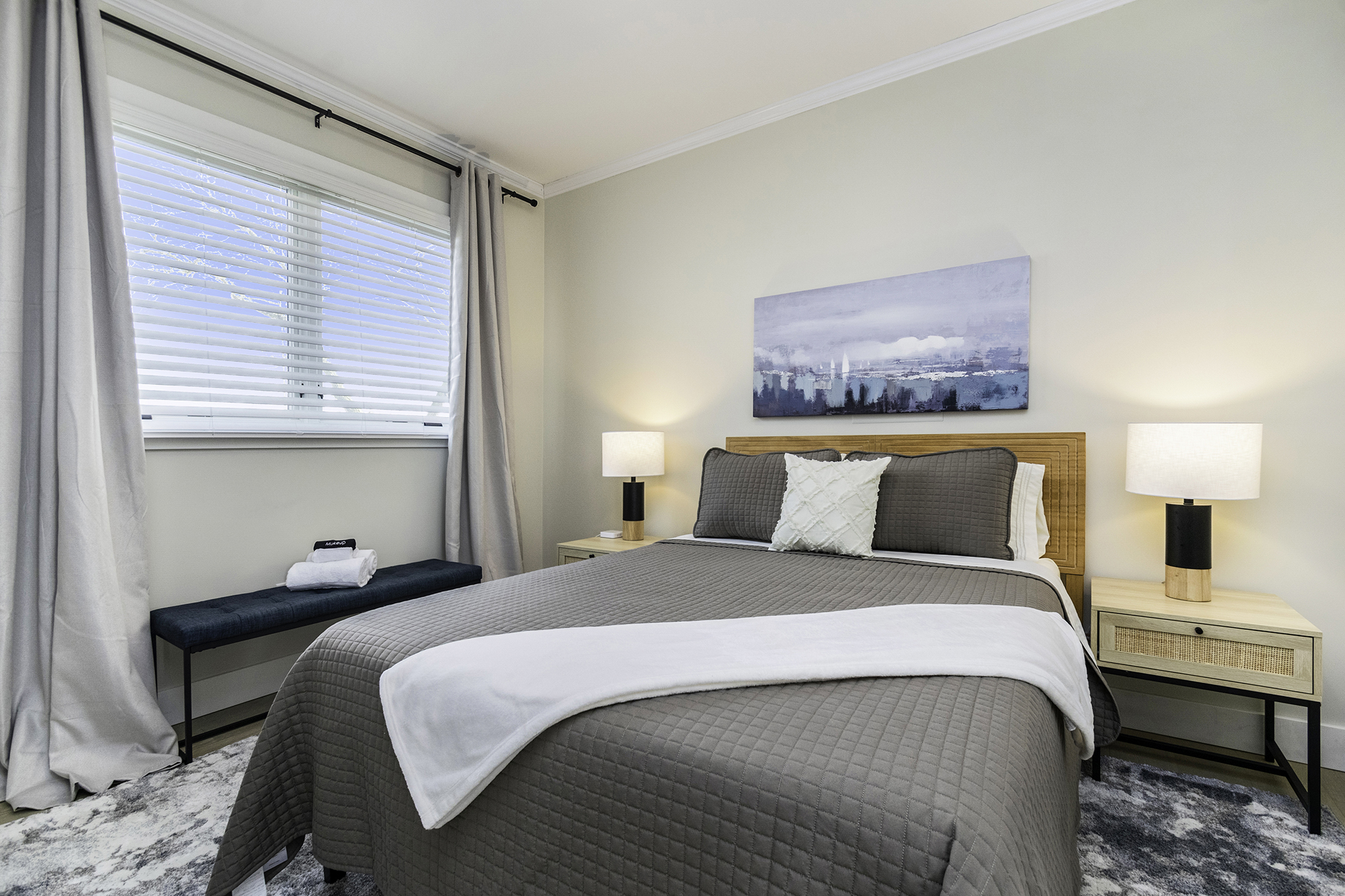 Modern bedroom with gray bedding and soft lighting