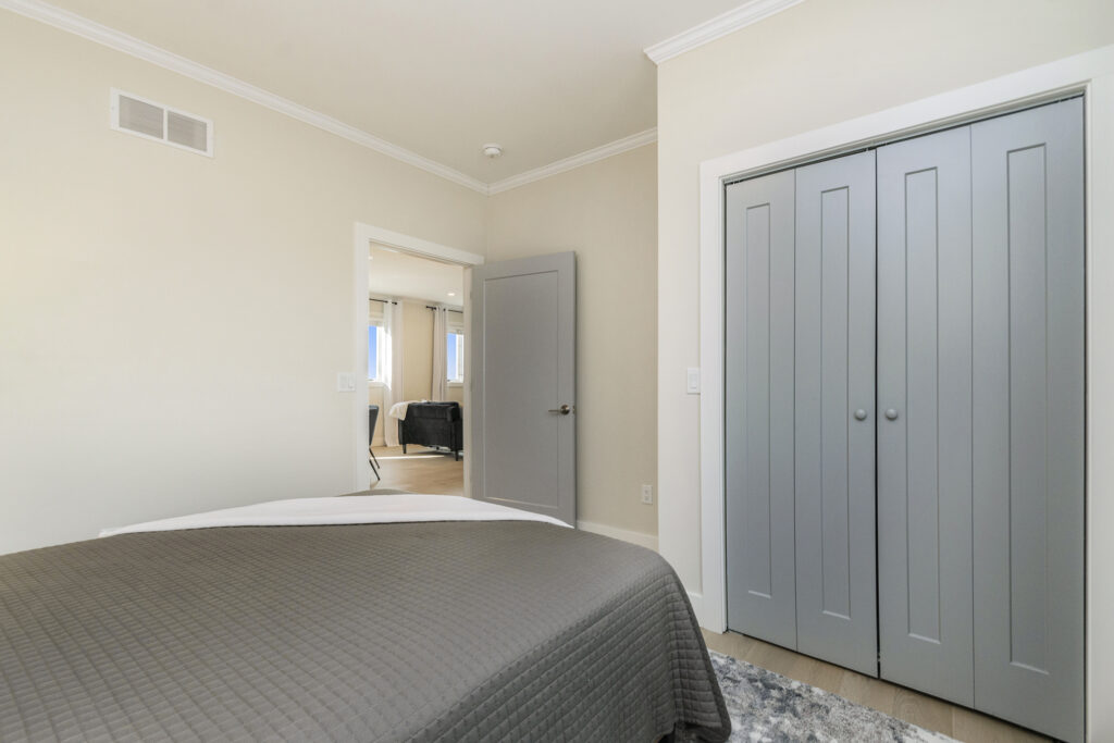 Modern bedroom with gray closet doors