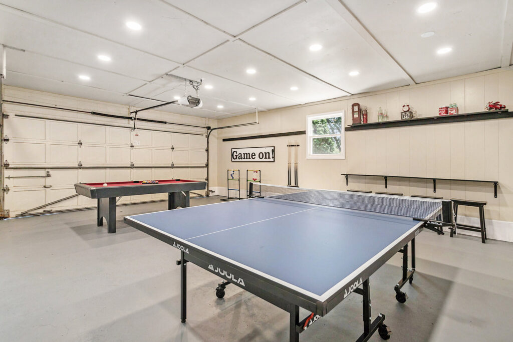 Garage game room with ping pong and pool table