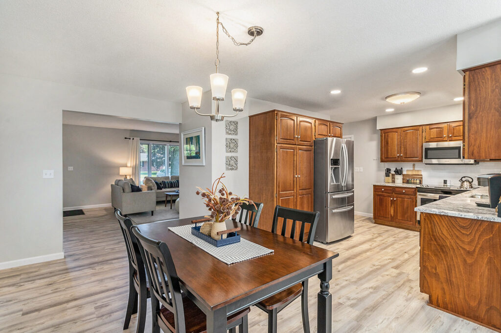 Modern kitchen and dining area with wooden cabinets