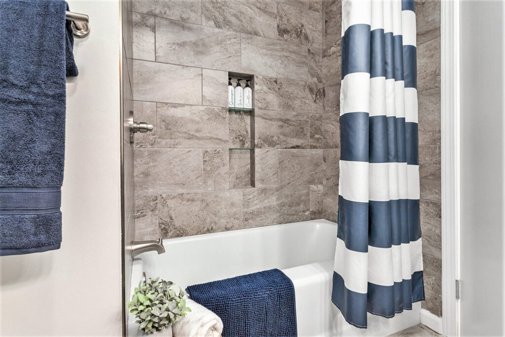 Modern bathroom with blue and white shower curtain