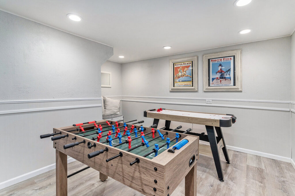 Basement game room with foosball and air hockey tables
