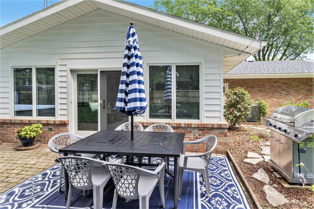 Outdoor patio with dining set and grill