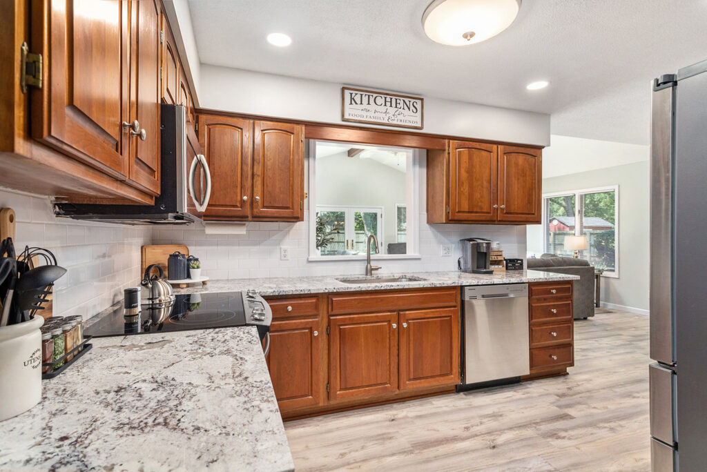 Modern kitchen with wooden cabinets and marble countertops