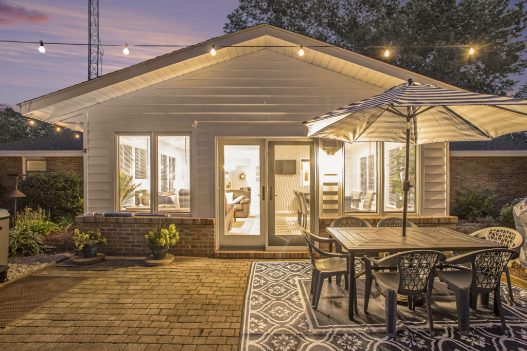 Cozy backyard patio with lights at sunset