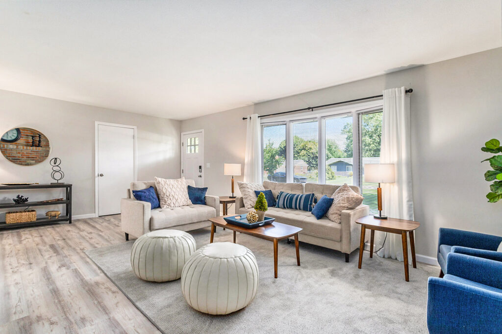 Modern living room with neutral decor and sunlight