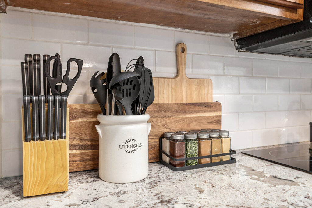 Kitchen utensils and spices on countertop