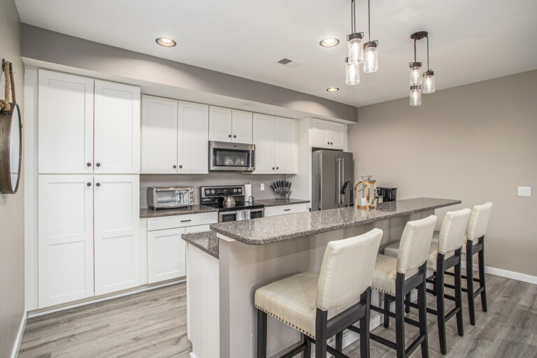 Modern kitchen with white cabinets and island seating