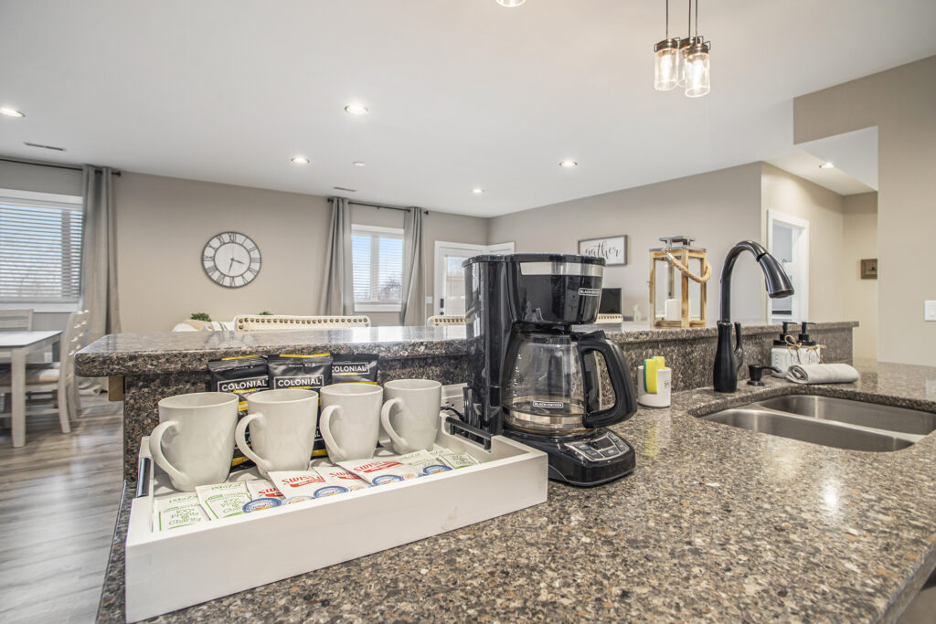 Modern kitchen with coffee maker and mugs