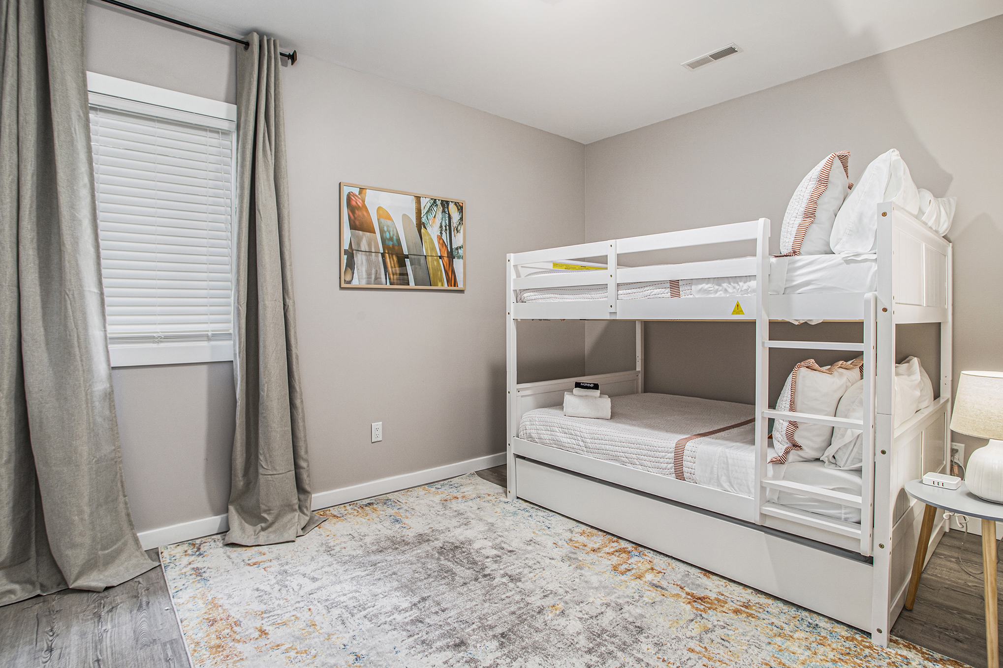 Modern bedroom with white bunk bed and decor