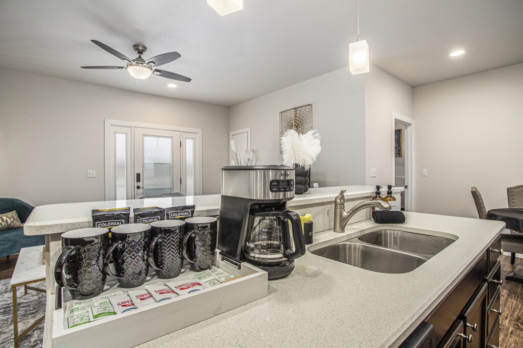 Modern kitchen counter with coffee maker and mugs