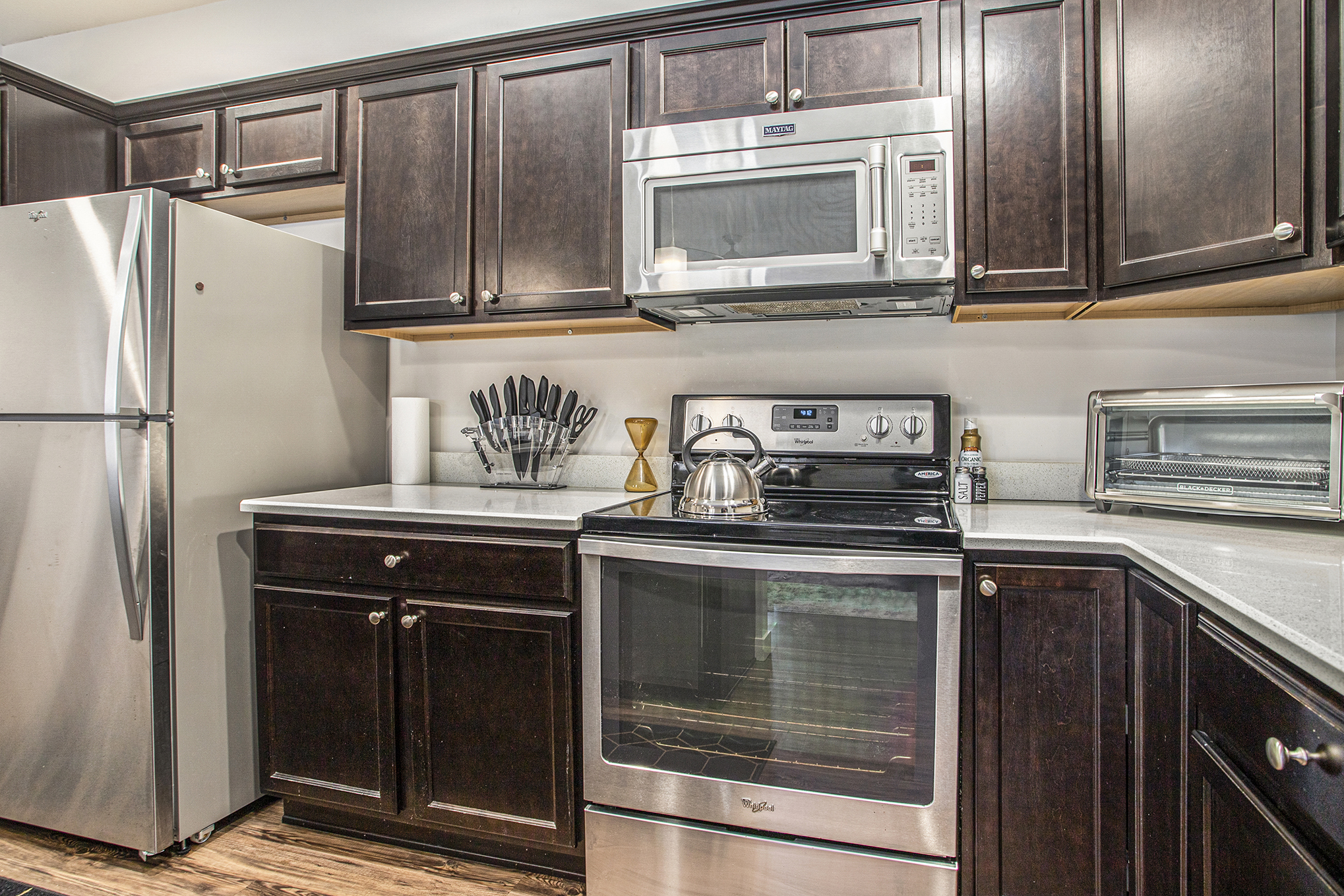 Modern kitchen with stainless steel appliances and dark cabinets