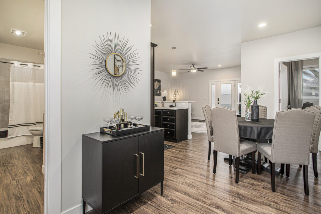 Modern dining room with kitchen and wall mirror