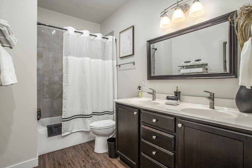 Modern bathroom with double sink and shower curtain