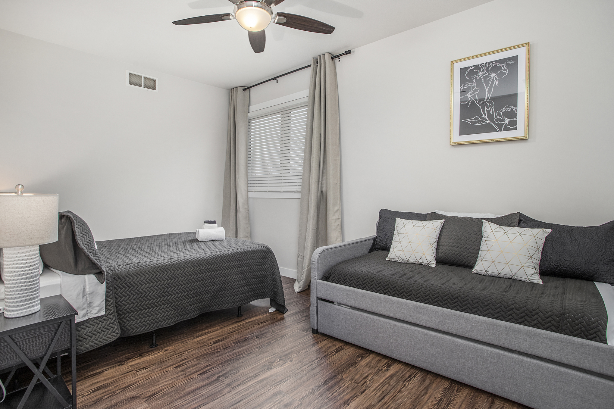 Modern bedroom with twin beds and wooden floor