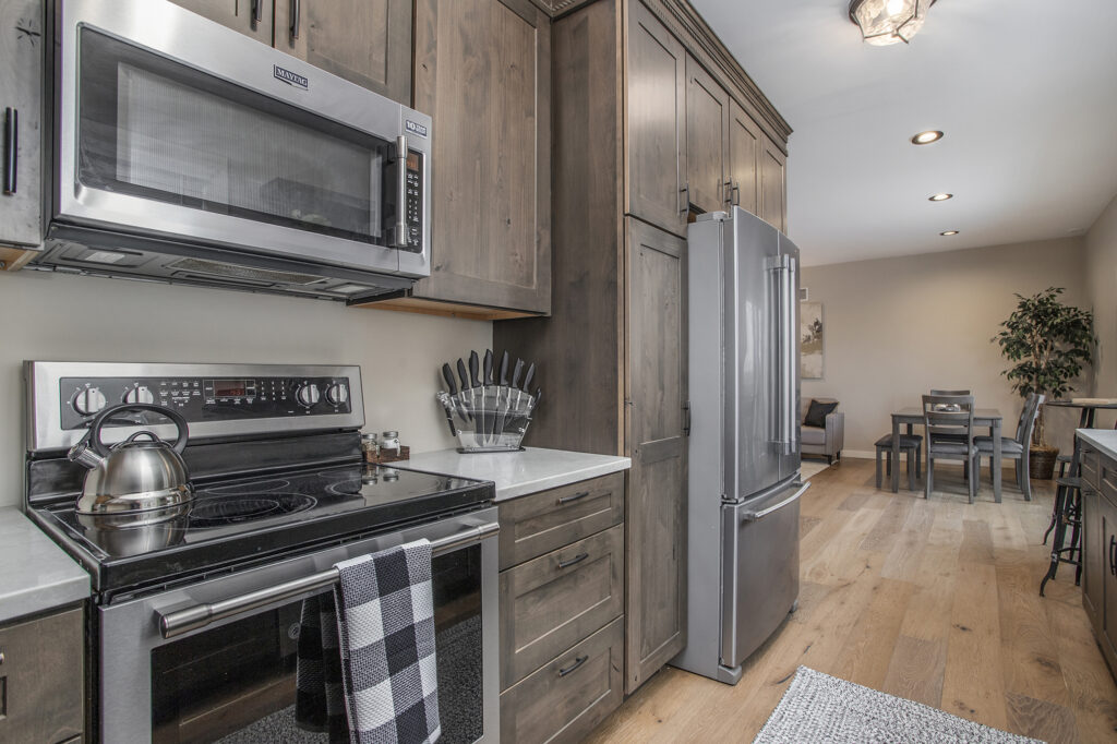 Modern kitchen with stainless steel appliances and wood cabinets