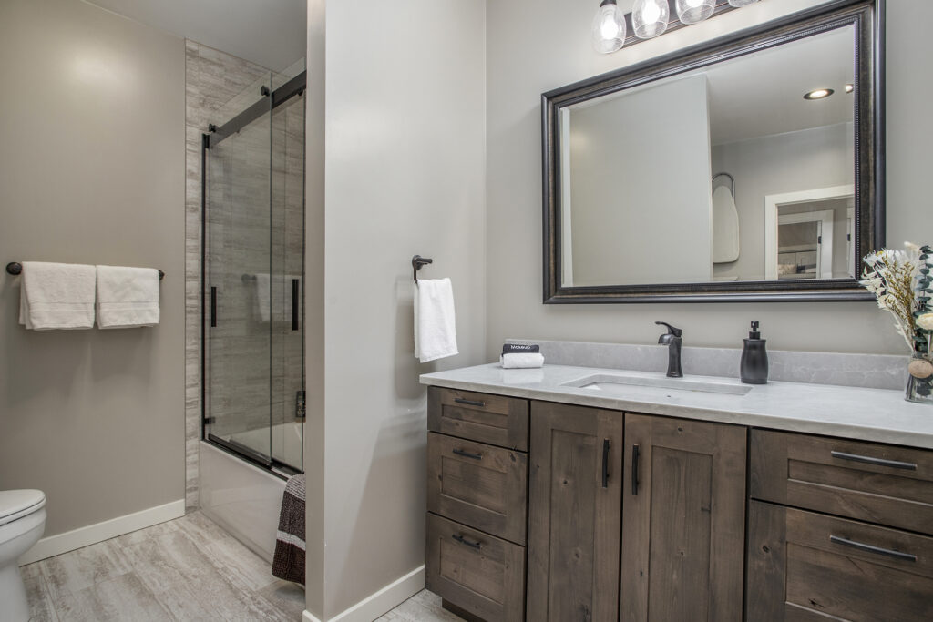 Modern bathroom with wooden vanity and glass shower