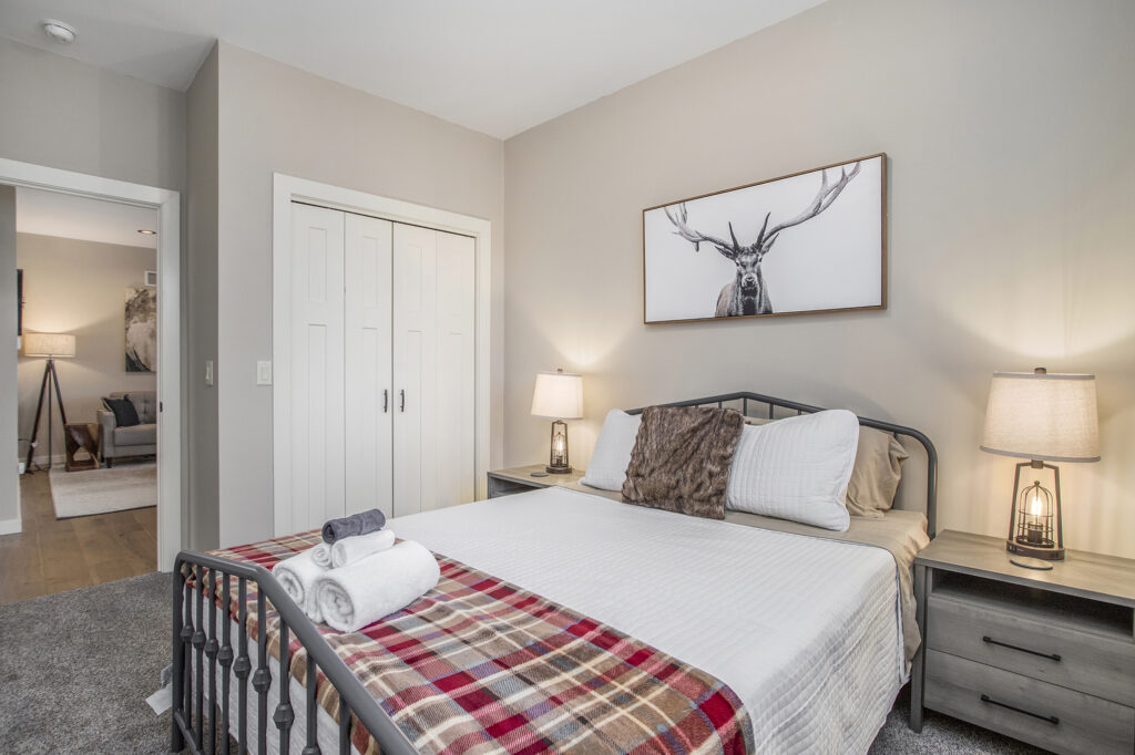 Cozy bedroom with bed and plaid blanket