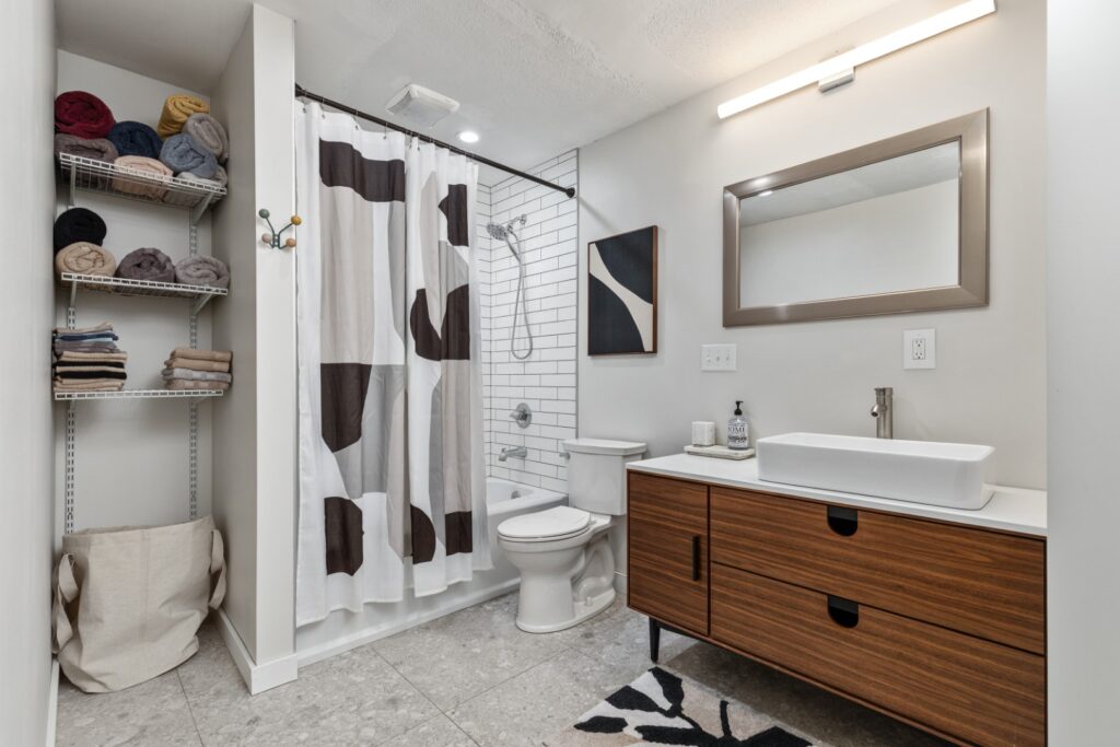Modern bathroom with wooden vanity and shower curtain