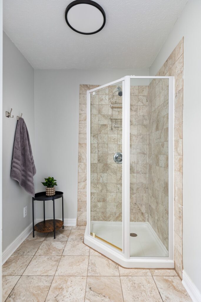 Modern tiled shower with glass door