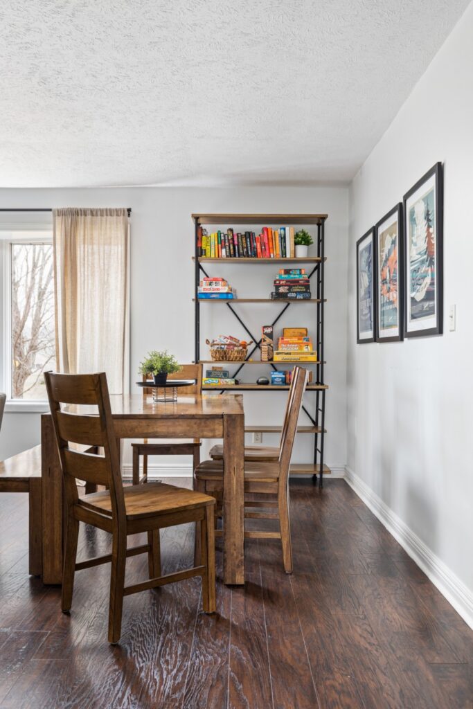 Dining area with wooden table and bookshelf