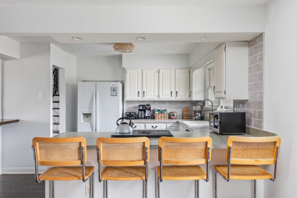 Modern kitchen with bar stools and white cabinets