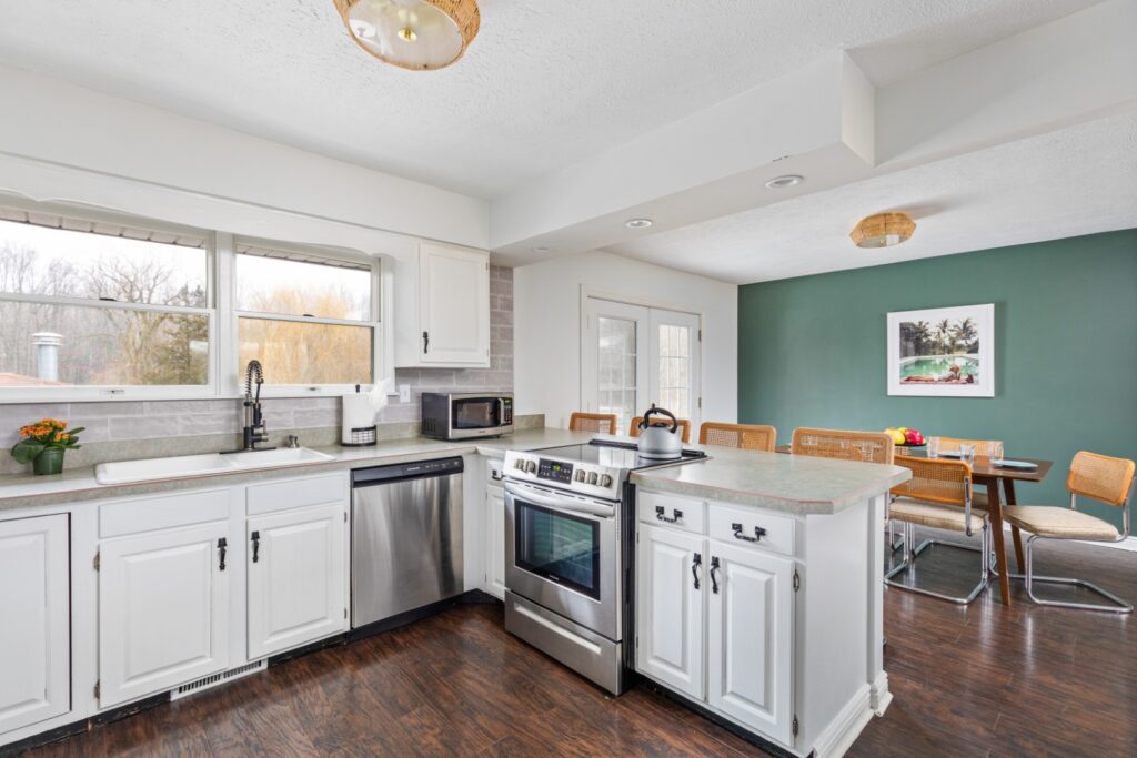 Modern kitchen with white cabinets and dining area