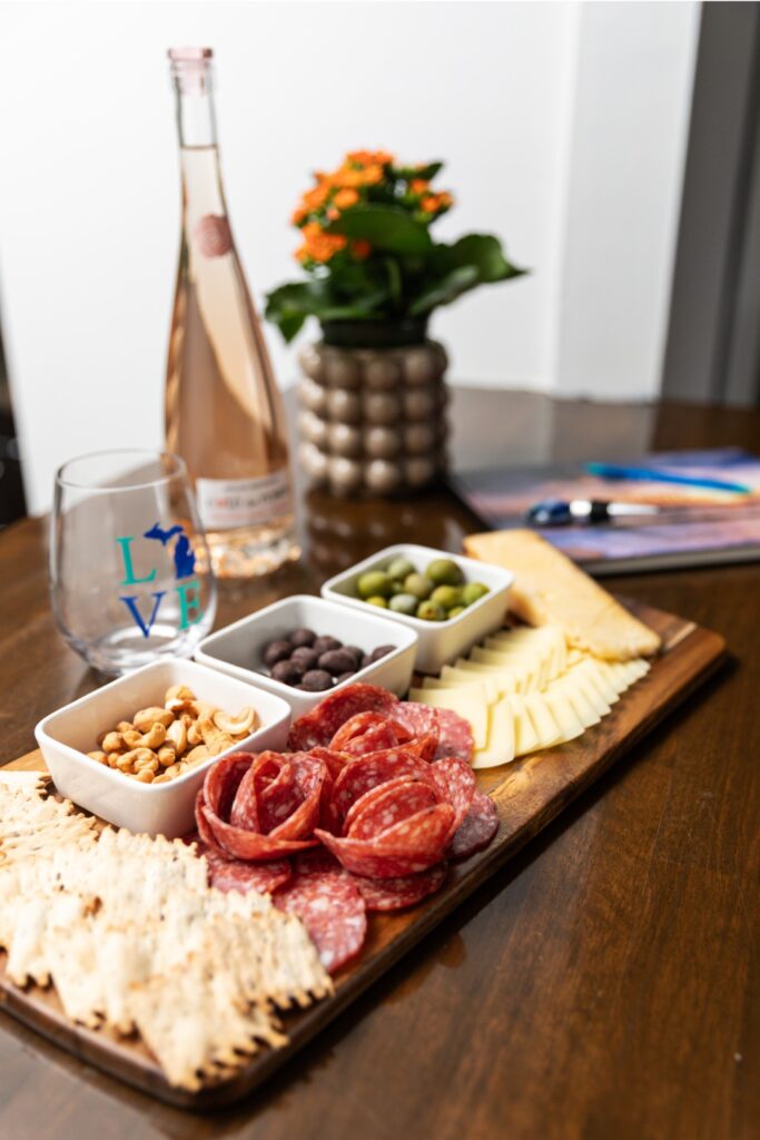 Charcuterie board with wine and snacks