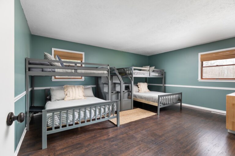 Bedroom with gray bunk beds and green walls