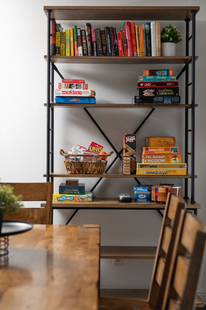 Bookshelf with books and board games in dining area