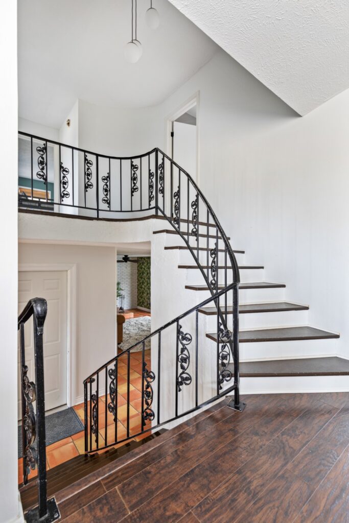 Curved staircase with wrought iron railing indoors