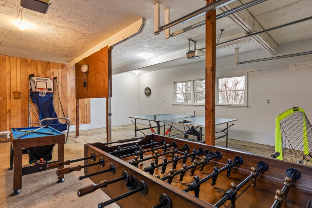 Garage game room with foosball and ping pong tables
