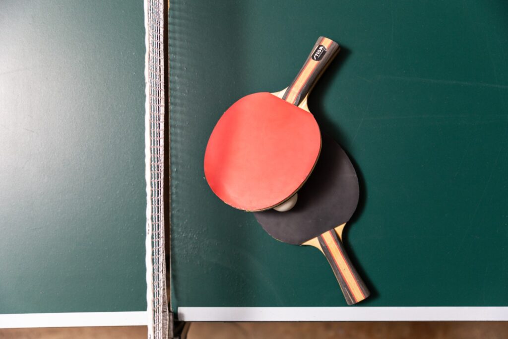 Ping pong paddles on green table