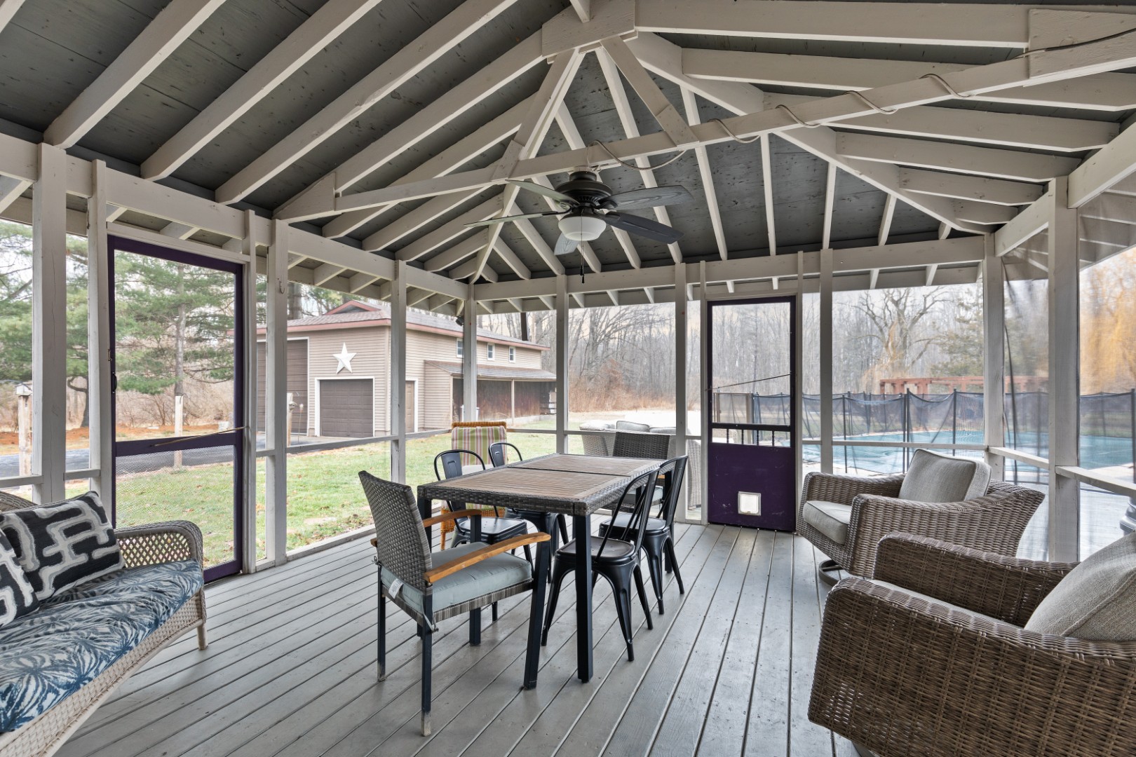 Screened porch with outdoor dining and seating area