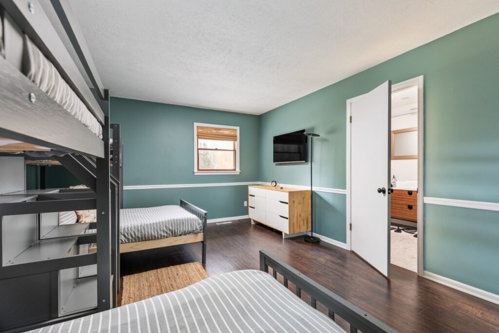 Modern bedroom with bunk beds and teal walls