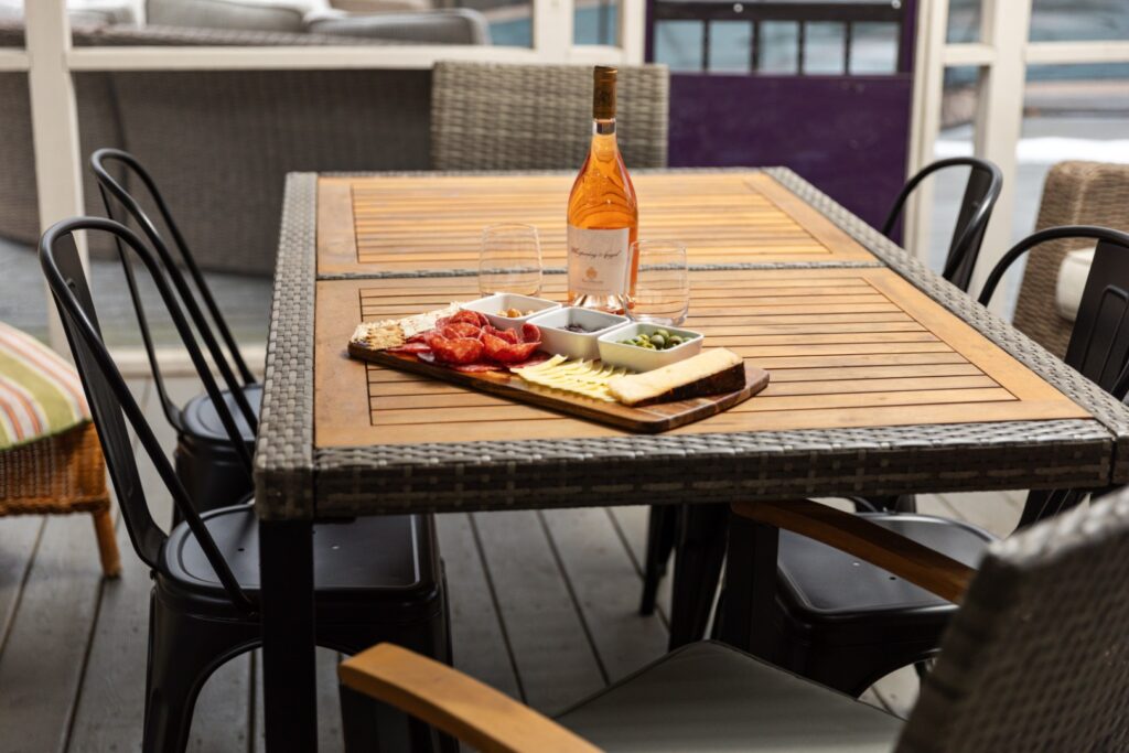 Outdoor table with wine and charcuterie board