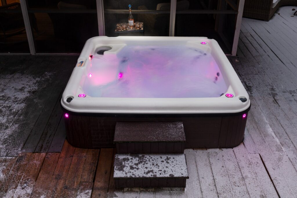 Outdoor hot tub with pink LED lights