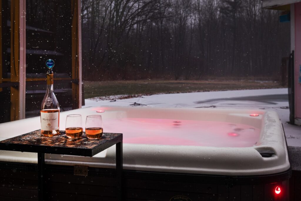 Hot tub with wine on snowy evening